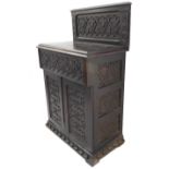 A 17th century style (later) carved oak side cabinet: the galleried back carved with vertical