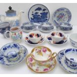 An assortment of mostly 19th century ceramics to include cups and saucers, a teapot and an