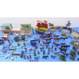 A toy farm made up of mostly mid-19th century metal farm figures and wooden farm buildings. The farm