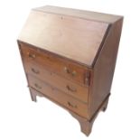 An Edwardian mahogany and satinwood crossbanded writing bureau; the fall opening to reveal
