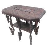 An unusual and highly ornate early 20th century carved centre table; the central tablet depicting
