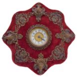 A desk timepiece made by the British United Clock Co., Birmingham, in a red velvet and gilt-metal