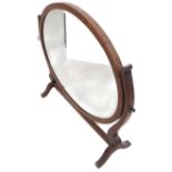 An oval mahogany framed toilet mirror (66cm wide)