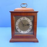 A walnut cased  mantle clock by 'Smith's English Clock's Ltd'; silvered dial with Roman Numerals and