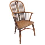 An early/mid 19th century Windsor chair; pierced splat, yew wood bows, shaped elm seat and turned