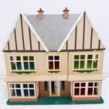 A large hand-painted and custom-made double-fronted doll's house (93cm wide x 80cm highest point)