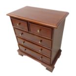 A modern mahogany 18th century style chest of small proportions; thumbnail moulded top above two