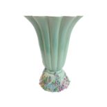 A 1930s /1940s Clarice Cliff vase of flowering fluted form and with flower encrusted base, signed in