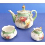 A late 19th / early 20th century three-piece porcelain tea service by Hadley's of Worcester: teapot,
