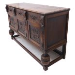 An early 20th century oak sideboard in Elizabethan style; the thumbnail moulded top above a