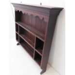 A 19th century oak dresser rack; the outset cornice above a wavy frieze and three-tiered shelving (