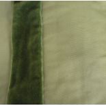 A pair of curtains in a heavy green twill-type fabric embellished with strip of green velvet,