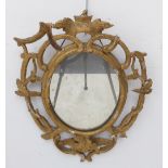 A 19th century gilt framed oval looking glass for restoration; the pierced frame carved as branches,
