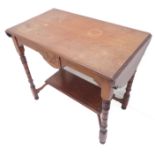 An Edwardian walnut occasional table; central tablets incised with swags and flanked by two drop-