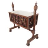 A mid-19th century mahogany-framed child's cot with rocking action; two turned uprights and a