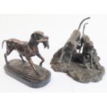 A heavy cast bronze of a gun dog with pheasant upon an oval variegated marble base (in the 19th