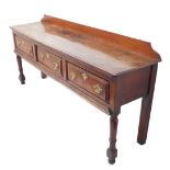 An 18th century oak dresser base; the later galleried, moulded top above three frieze drawers with
