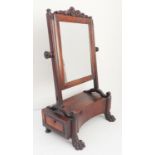 An unusual early 19th century toilet mirror; the cushion moulded frames surmounted with foliate-
