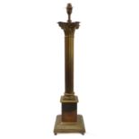 A large brass table lamp modelled as a classical-style Corinthian column with acanthus capital and