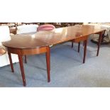 A George III period D-end mahogany drop leaf dining table; the central section with two drop
