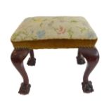 A heavy Victorian mahogany stool with period tapestry seat, shaped legs with ball-and-claw feet (