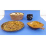 Four pieces of slipware decorated Winchcombe Pottery: an oval slipware dish decorated with a