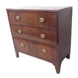 An early 19th century mahogany chest; the reeded edge top above three full-width graduated drawers