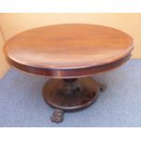 An early Victorian circular tilt top breakfast table; inverted turned stem leading down to carved