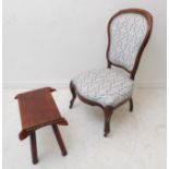 A 19th century walnut nursing chair of small proportions; spoon back, later upholstered,