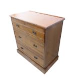 An early 20th century oak/walnut chest having three full-width drawers, raised on plinth base (