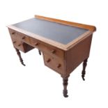 A 19th century oak desk; leather inset moulded top above an arrangement of two half-width and two