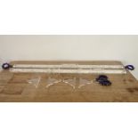 Two tubed perspex and chrome curtain poles stuffed with white feathers (136cm), together with