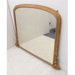 A large 19th century overmantle looking glass (re-gilded / repainted); moulded arch frame and