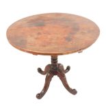 An early 19th century circular fruitwood-topped occasional table: the top 'married' to the base;