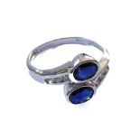 An 18-carat white gold, sapphire and diamond crossover ring, ring size N