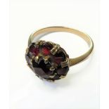 A 9-carat gold ring set with red garnets, ring size O (boxed)