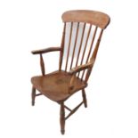 A late 19th century lathe-back chair having shaped elm seat and turned, slightly splaying legs