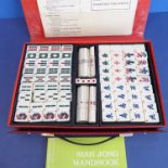 A late 20th century Mah Jong set, complete cased bamboo-backed set, with beginner's handbook.