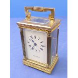 A heavy gilt-metal carriage clock by Mappin & Webb Ltd; white dial with Roman numerals flanked by