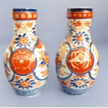 A pair of two-handled Noritake vases; hand decorated and gilded with upper Art Deco style motifs,