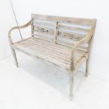A Regency-style slatted garden bench; horizontal back bars and on turned tapering legs (115.5cm wide