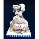 A Peggie Foy pottery figure of the Duchess, the Pig Baby and the Cheshire Cat, painted 'FOY' mark to