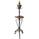 An unusual black-painted wrought-iron brass-mounted lamp standard; the hand-beaten circular copper