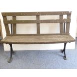 A custom-made garden bench; slatted back, natural bow-fronted wooden seat and on ironwork ends (