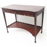 A George III style mahogany side table; the serpentine-fronted overhanging rosewood crossbanded