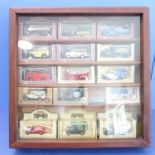 15 boxed die-cast models within a polished hardwood case (49cm square). The models to include six