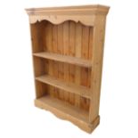 A modern pine open bookcase; three shelves and on bracket style feet (95cm wide x 23cm deep x