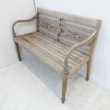 A Regency-style slatted garden bench; horizontal back bars and on turned tapering legs (115.5cm wide