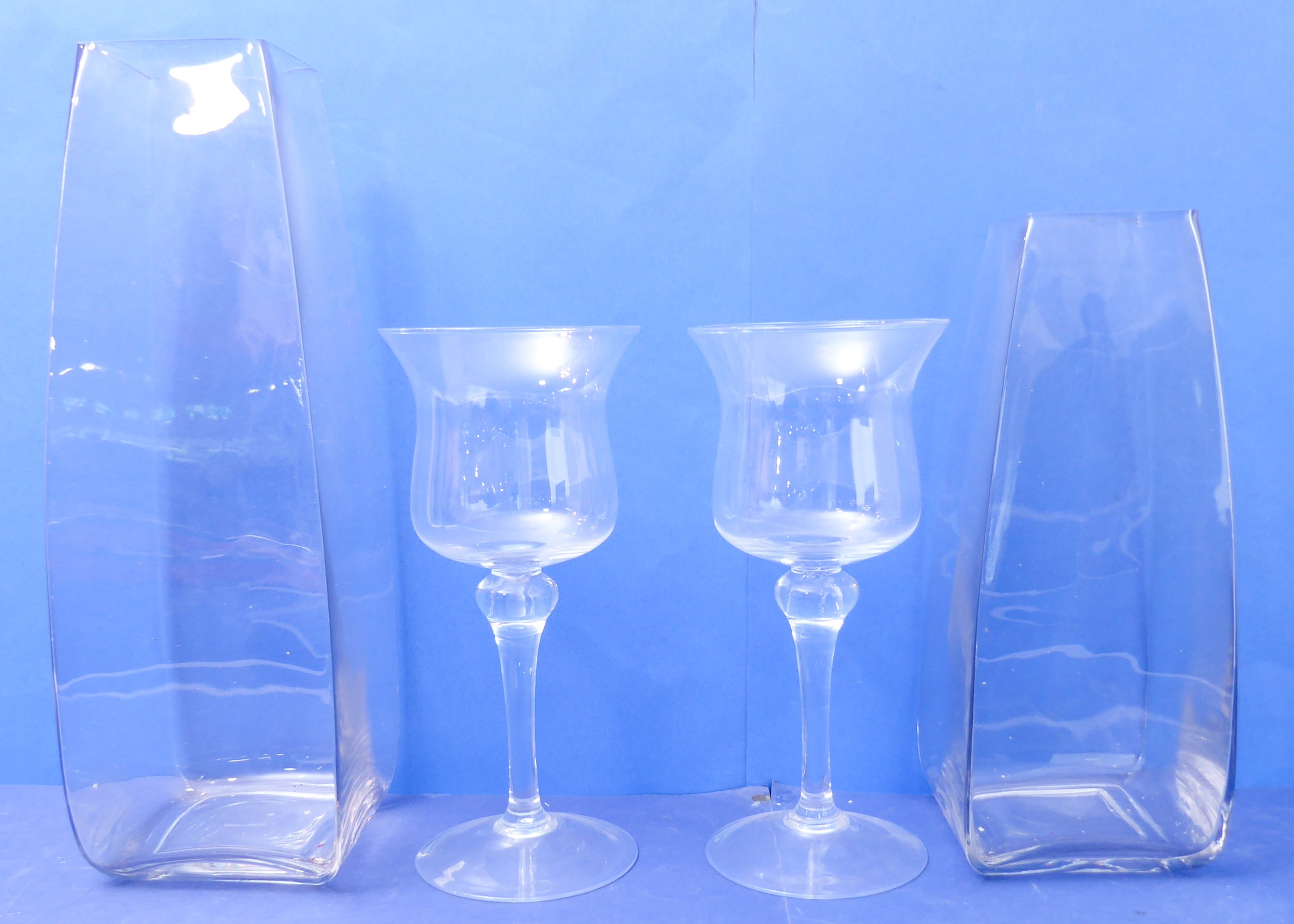 A pair of oversized wine glasses with tulip-shaped bowls (34cm high), together with two larger