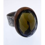 A bespoke made silver ring; textured outer and then hand-cut oval stone (possibly citrine ?) set